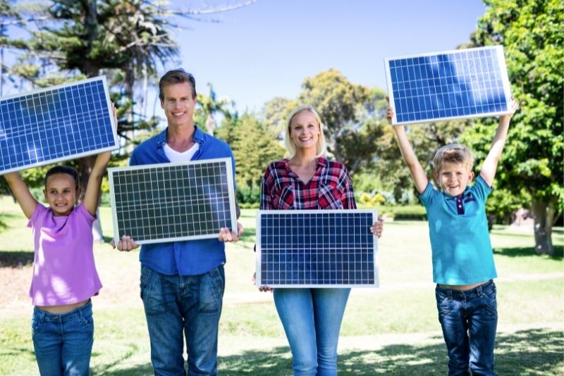 People Holding Solar Panelss