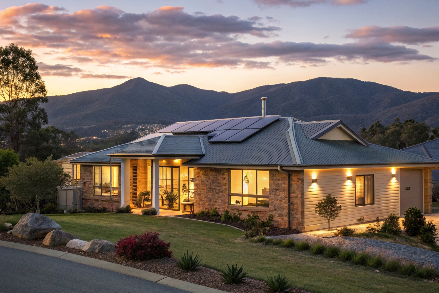 modern-australian-suburban-home-at-dusk-with-warm- Hobart home with solar panels and battery storage at evening time